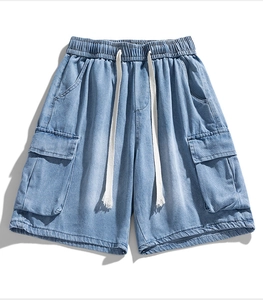 Close-up of light blue washed denim cargo shorts featuring elastic waistband and drawstrings