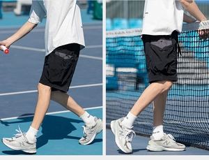 Macro detail of black cargo shorts featuring quick-dry nylon fabric and 3D utility pockets