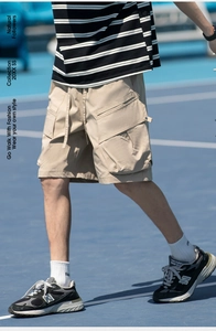 Detailed view of khaki cargo shorts with side flap pockets and adjustable drawstring waist