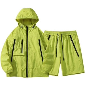 Neon green hooded windbreaker and shorts set with zipper pockets for outdoor sports