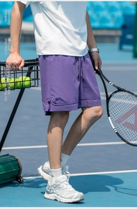 Dettaglio dei pantaloncini sportivi viola con tasche laterali e coulisse in vita