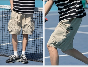 Detail view of khaki techwear cargo shorts with utility pockets and quick-dry fabric