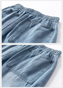 Detail of light blue washed denim shorts featuring elastic waist and large rear pockets