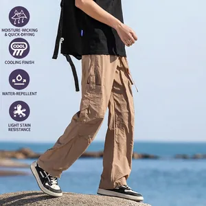 Men's khaki quick-dry outdoor cargo pants with multi-pocket design on seaside rocks