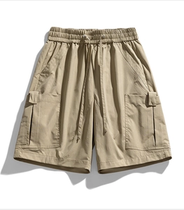 Detail of khaki cargo shorts with elastic drawstring waist and large side pockets