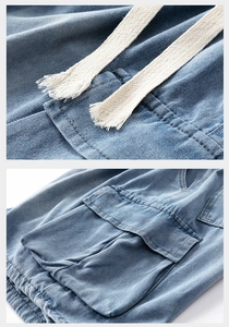 Detailed macro view of denim shorts featuring woven drawstrings and utility cargo pockets
