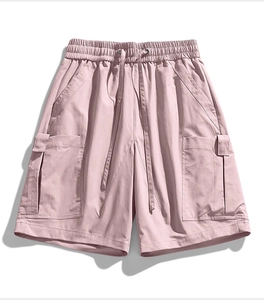Detail view of pink cargo shorts featuring elastic drawstring waist and large 3D side pockets