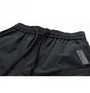 Detail of cargo shorts elastic waistband with drawstring and Never Stop Exploring tag