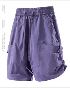 Detailed macro view of deep purple cargo shorts with elastic drawstring and utility pockets