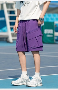 Detail of purple cargo shorts with large 3D side pockets and elastic drawstring waistband