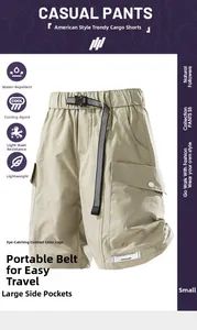 Detail showing water-repellent khaki cargo shorts with functional pockets and belt