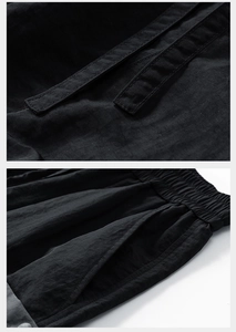 Detail of the elastic waistband and reinforced side pockets on these black summer shorts