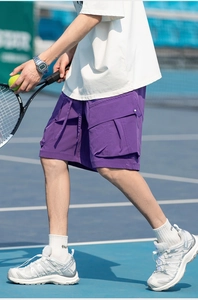 Detail of purple cargo shorts featuring textured quick-dry fabric and 3D utility pockets