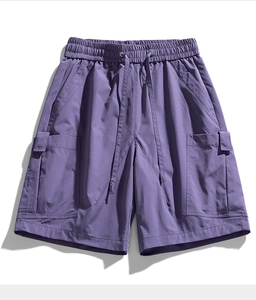 Detail of purple cargo shorts featuring elastic waistband and large side flap pockets