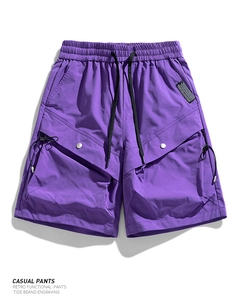 Detail of purple cargo shorts featuring elastic drawstring waist and side tactical pockets