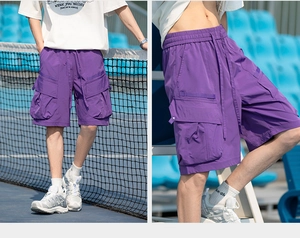 Detail view of purple cargo shorts featuring functional multi-pockets and drawstring waist
