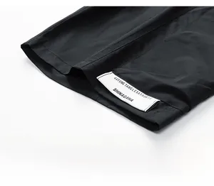 Détail du short cargo noir déperlant avec étiquette blanche tissée sur le bas de la jambe