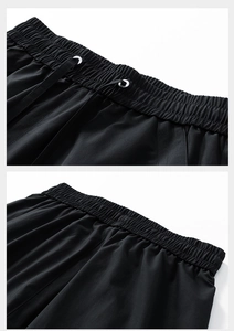 Detail view of the black sports shorts featuring an elastic drawstring waistband and metal eyelets