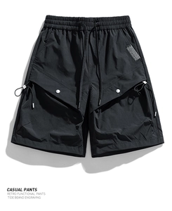 Detailed shot of waterproof cargo shorts featuring drawstring waist and functional pockets