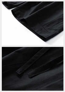 Close-up of black cargo shorts featuring reinforced double stitching and adjustable straps