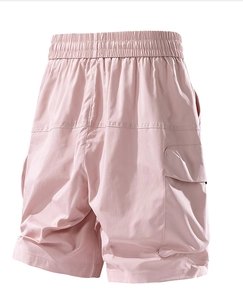 Detail of pink cargo shorts featuring wide elastic waistband and large flap pockets