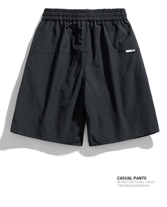 Detailed view of black water-repellent cargo shorts with elastic waist and brand patch