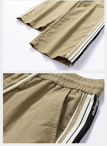 Dettaglio di pantaloncini casual kaki con strisce laterali e vita elastica con coulisse