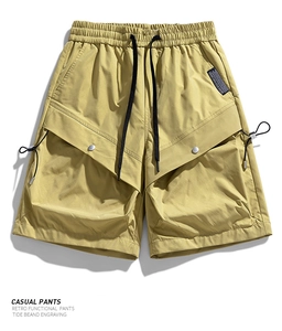 Detail of khaki cargo shorts with elastic waist, drawstring, and snap button V-pockets
