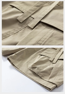 Detail of khaki cargo shorts showing the woven fabric texture and utility flap pockets