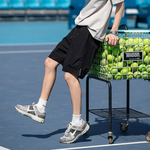 Pantaloncini sportivi neri da uomo ad asciugatura rapida con strisce laterali sul campo