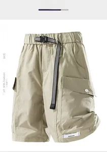 Detailed close-up of water-resistant cargo shorts with checkered belt and side pocket