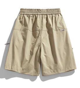 Detailed view of khaki water-repellent cargo shorts with elastic waist and brand tag