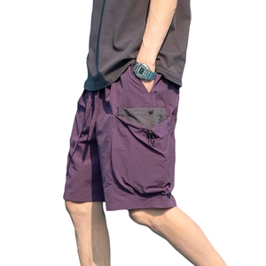 Men's purple nylon cargo shorts with elastic drawstring waist and multi-pocket design