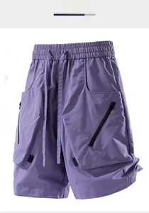 Detailed view of purple cargo shorts featuring elastic drawstring waist and side zipper pockets