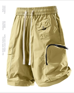 Detail view of khaki cargo shorts with elastic drawstring waist and large zipper pocket
