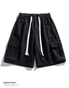 Close-up of black cargo denim shorts with drawstring waistband and large side utility pockets