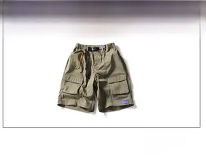 Detail view of olive green cargo shorts with tactical pockets and adjustable belt