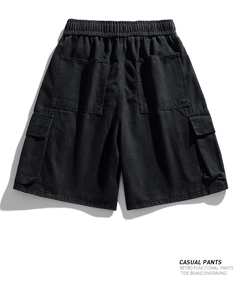 Detailed view of black cargo denim shorts with large pockets and elastic drawstring waist