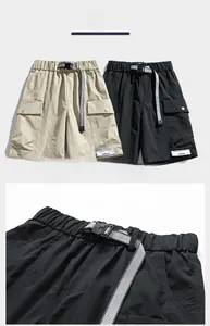 Detailed view of water-resistant cargo shorts with adjustable belts and utility pockets