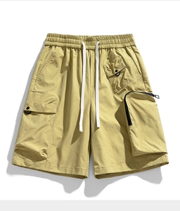 Detail view of water-resistant cargo shorts with functional zip pockets and drawstring waist