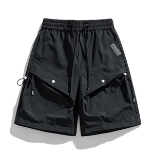 Water-resistant black cargo shorts with elastic drawstring waist and large flap pockets