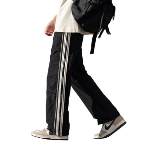 Pantaloni sportivi neri con strisce laterali bianche e orlo con spacco per uomo e donna