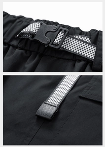 Detail shot of tactical buckle and black and white checkered webbing on cargo shorts
