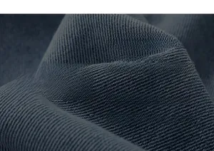 Macro view of washed dark grey denim fabric texture and twill weave for cargo shorts