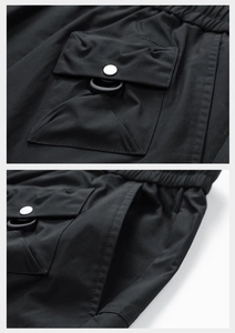 Detail of durable water-repellent cargo pants featuring tactical pockets and drawstring waist