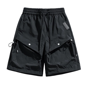 Water-resistant black tactical cargo shorts with elastic waist and large side flap pockets