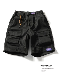 Detail of black cargo shorts with adjustable buckle belt and large utility side pockets