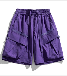 Detail of purple cargo shorts featuring elastic drawstring waist and tactical side pockets