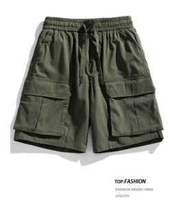 Detail of army green cargo shorts with elastic drawstring waist and flap pockets