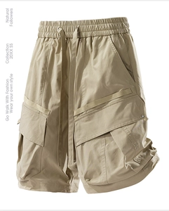 Detail showing elastic drawstring waist and large flap cargo pockets on khaki shorts